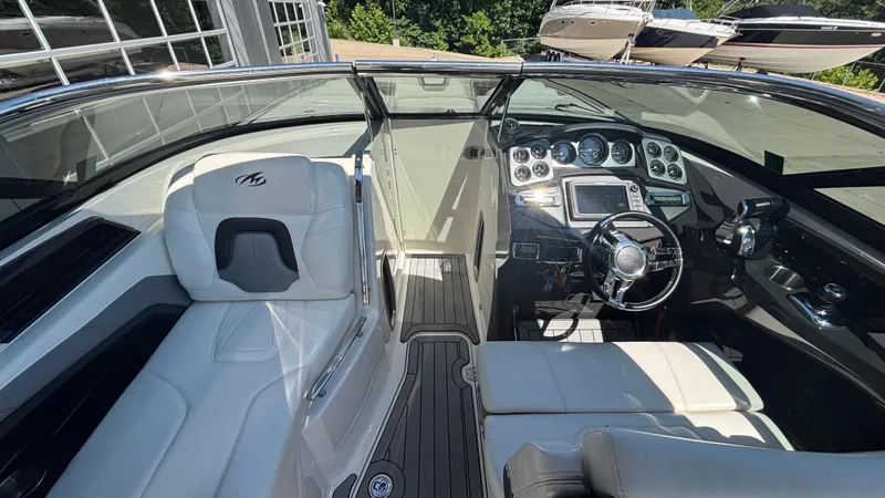 Slide: The Image of 2014 Monterey 328 Super Sport boat interior with sleek dashboard and luxurious seating. - 32