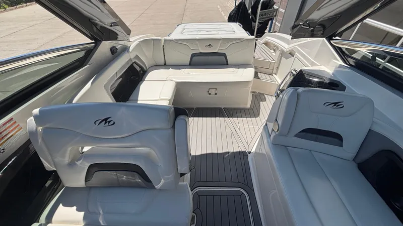 Slide: The Image of 2014 Monterey 328 Super Sport boat interior with white seating and sleek design. - 34