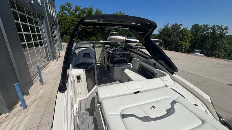 Slide: The Image of 2014 Monterey 328 Super Sport boat with sleek interior and modern design, docked outdoors. - 35