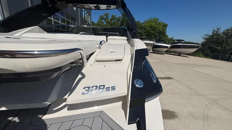 Slide: The Image of 2014 Monterey 328 Super Sport boat on display in a sunny outdoor setting. - 37