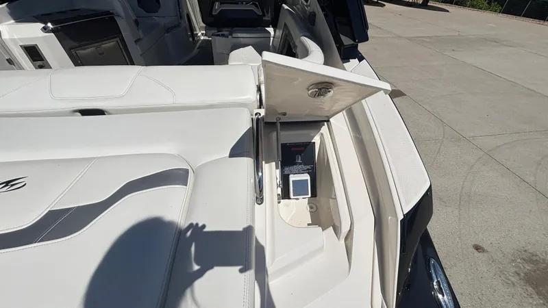 Slide: The Image of 2014 Monterey 328 Super Sport boat interior with open storage compartment on deck. - 38