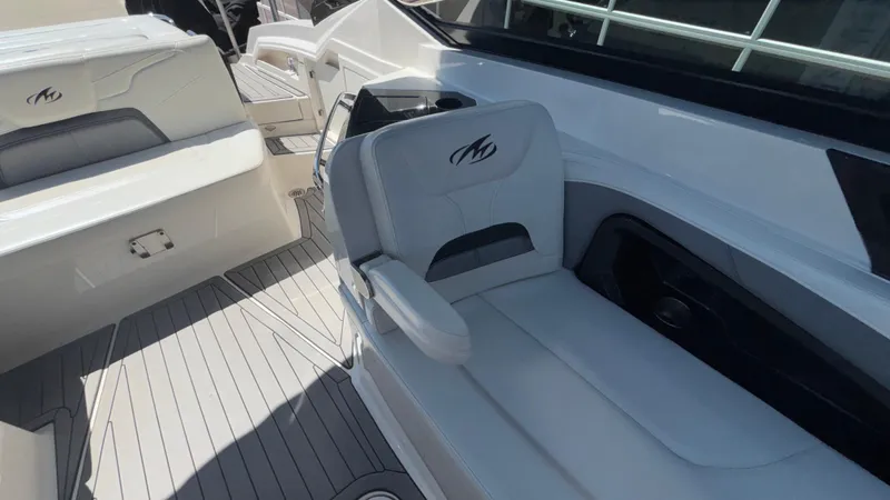 Slide: The Image of 2014 Monterey 328 Super Sport boat interior with white seating and sleek design. - 40