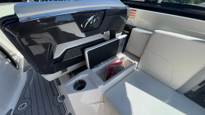 Slide: The Image of 2014 Monterey 328 Super Sport boat interior with white seating and storage compartment. - 41