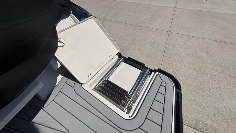 Slide: The Image of 2014 Monterey 328 Super Sport boat ladder and storage compartment on deck. - 5