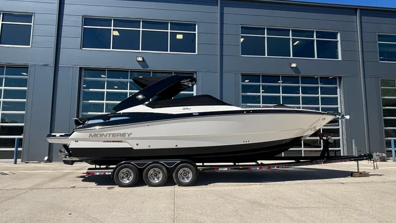 Slide: The Image of 2014 Monterey 328 Super Sport boat on trailer outside industrial building. - 9