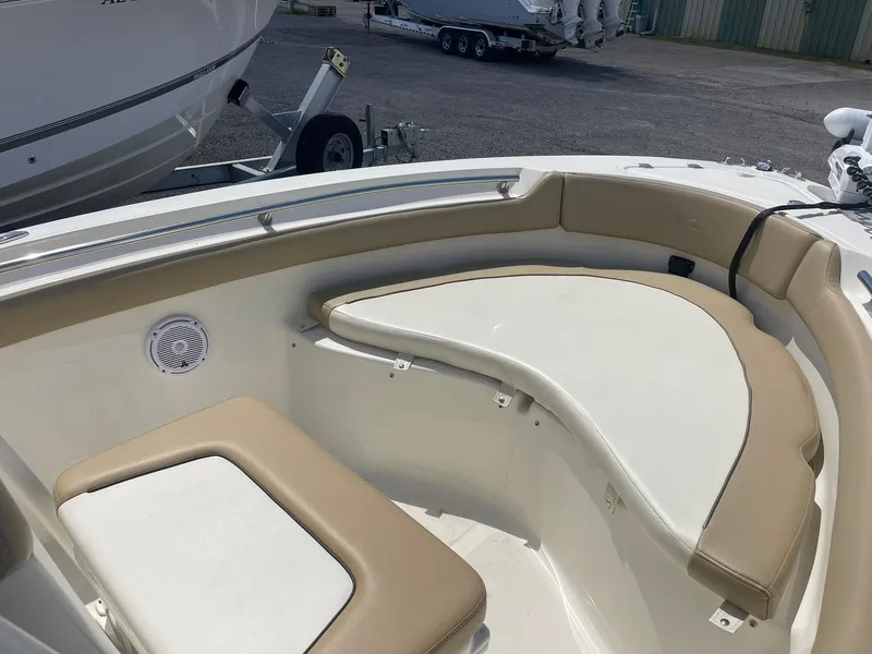 Slide: The Image of 2019 Pioneer 202 Sportfish boat interior with cushioned seating and speaker. - 11