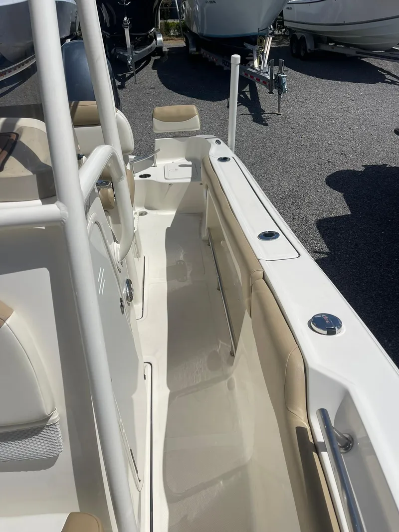 Slide: The Image of 2019 Pioneer 202 Sportfish boat interior with beige seating and white deck. - 12