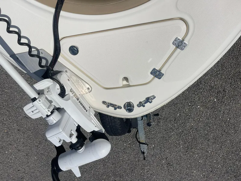 Slide: The Image of 2019 Pioneer 202 Sportfish boat bow with trolling motor on asphalt surface. - 13