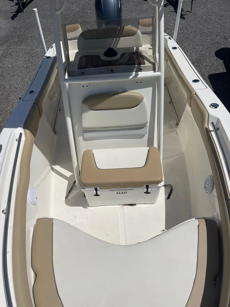 Slide: The Image of 2019 Pioneer 202 Sportfish boat interior with beige seating and center console. - 14