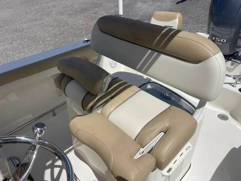 Slide: The Image of 2019 Pioneer 202 Sportfish boat interior with tan and white seating. - 16