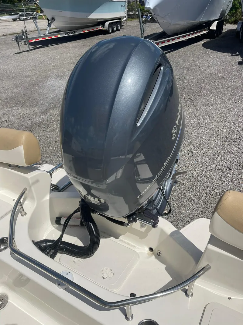 Slide: The Image of 2019 Pioneer 202 Sportfish boat with Yamaha outboard motor in a parking lot. - 18