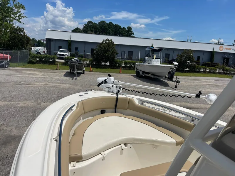 Slide: The Image of 2019 Pioneer 202 Sportfish boat with seating, parked outdoors under a clear sky. - 3