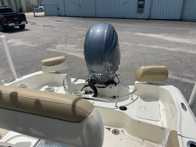Slide: The Image of 2019 Pioneer 202 Sportfish boat with Yamaha 150 outboard motor, parked outdoors. - 5