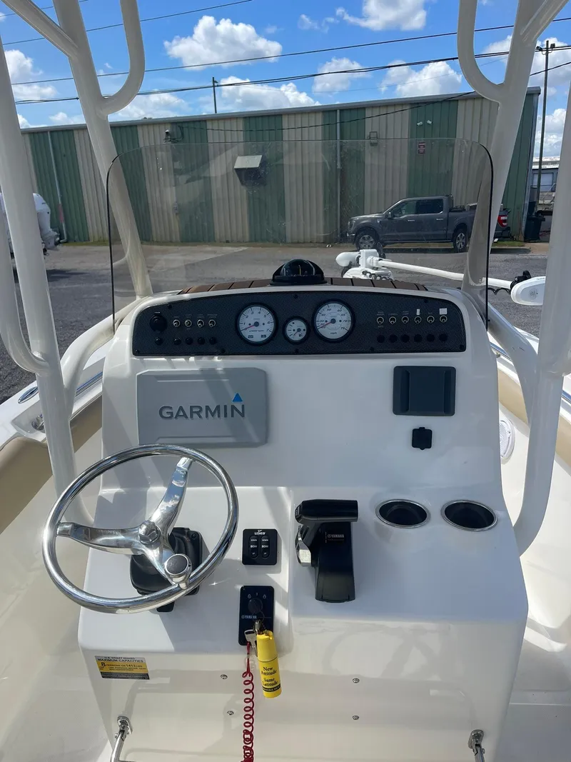 Slide: The Image of 2019 Pioneer 202 Sportfish boat console with Garmin navigation, steering wheel, and gauges. - 8