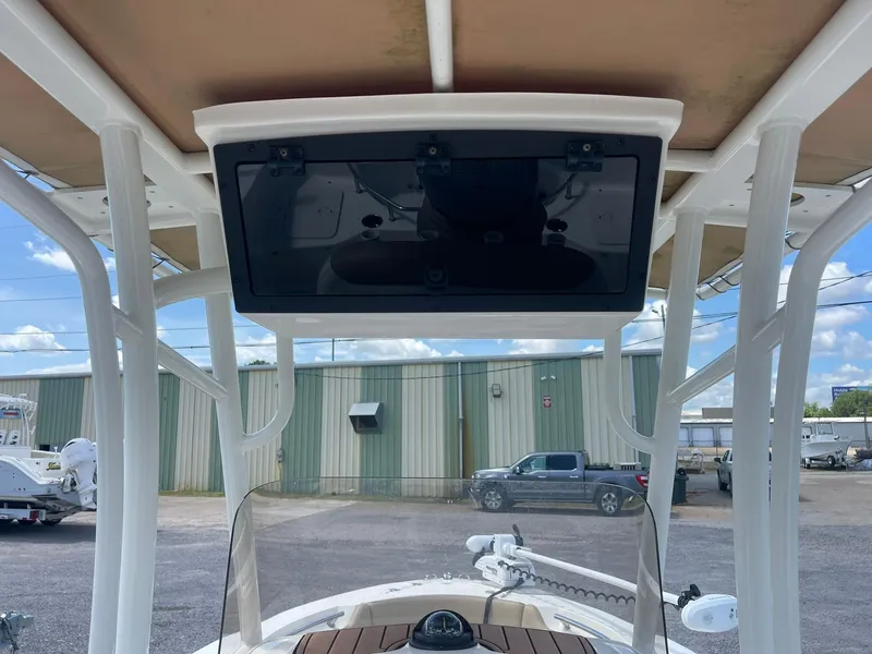 Slide: The Image of 2019 Pioneer 202 Sportfish boat with T-top and electronics, parked outdoors. - 9