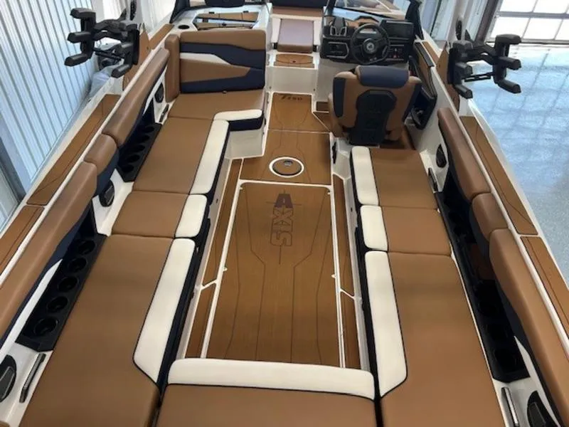 Slide: The Image of 2024 Axis T250 boat interior with brown and white seating, modern dashboard, and spacious layout. - 10