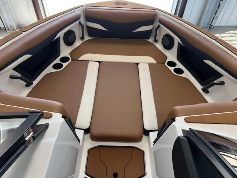 Slide: The Image of 2024 Axis T250 boat interior with brown and white seating, cup holders, and modern design. - 11