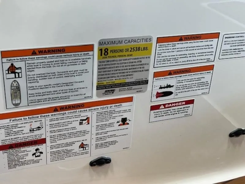 Slide: The Image of Warning labels on 2024 Axis T250 boat, indicating maximum capacity and safety instructions. - 13