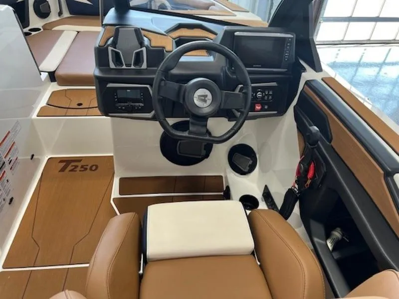 Slide: The Image of 2024 Axis T250 boat interior with modern dashboard and brown seating. - 14