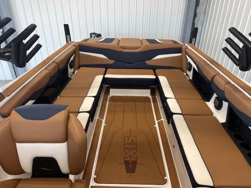 Slide: The Image of 2024 Axis T250 boat interior with brown and white seating, featuring sleek design and ample space. - 17