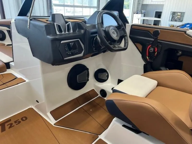 Slide: The Image of 2024 Axis T250 boat interior with modern dashboard and tan seating. - 18