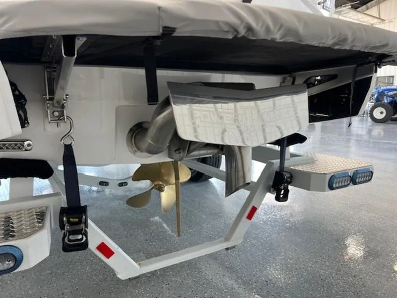 Slide: The Image of 2024 Axis T250 boat stern with propeller and exhaust system in a showroom. - 7