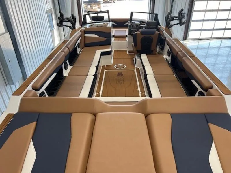 Slide: The Image of 2024 Axis T250 boat interior with spacious seating and modern design in a showroom. - 9