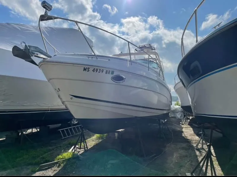 Slide: The Image of 2006 Rinker 300 Fiesta Vee boat on stands, sunny day, surrounded by other boats. - 3