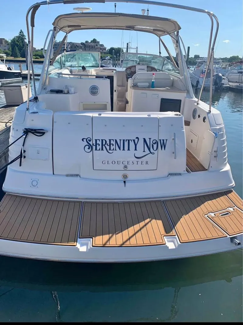 Slide: The Image of 2006 Rinker 300 Fiesta Vee boat named "Serenity Now" docked in Gloucester marina. - 4