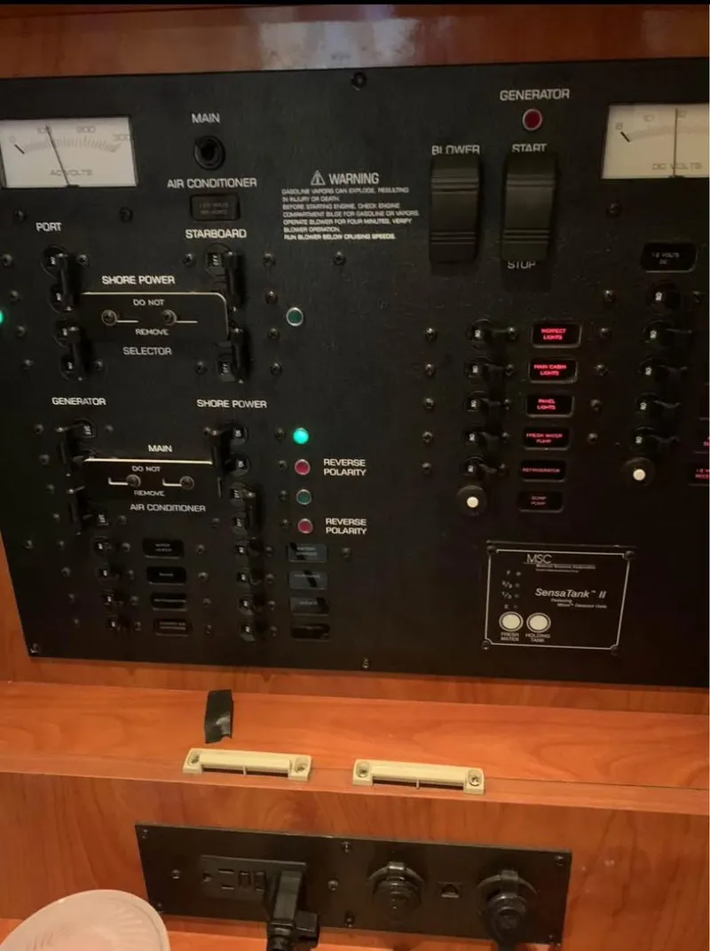 Slide: The Image of Control panel of a 2006 Rinker 300 Fiesta Vee boat, featuring switches and gauges. - 7