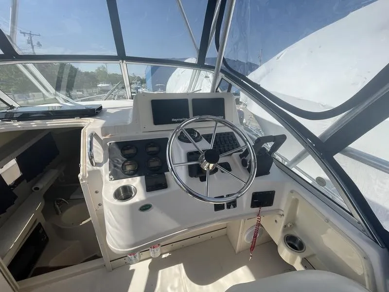 Slide: The Image of 2003 Grady-White Sailfish 282 helm with steering wheel and navigation instruments. - 12