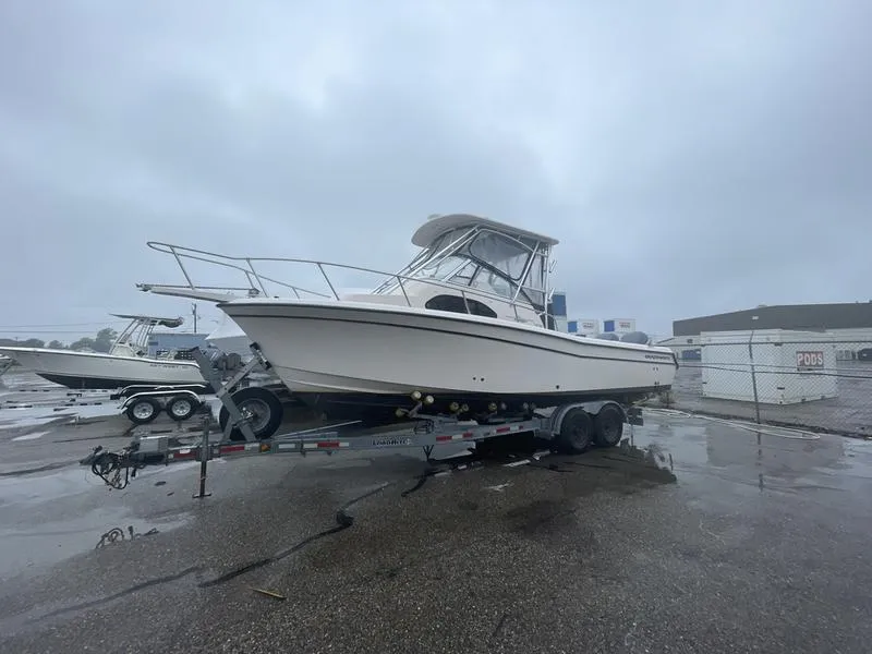 Slide: The Image of 2003 Grady-White Sailfish 282 boat on trailer in a wet parking lot. - 3