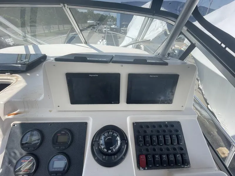 Slide: The Image of 2003 Grady-White Sailfish 282 helm with navigation screens and controls. - 4