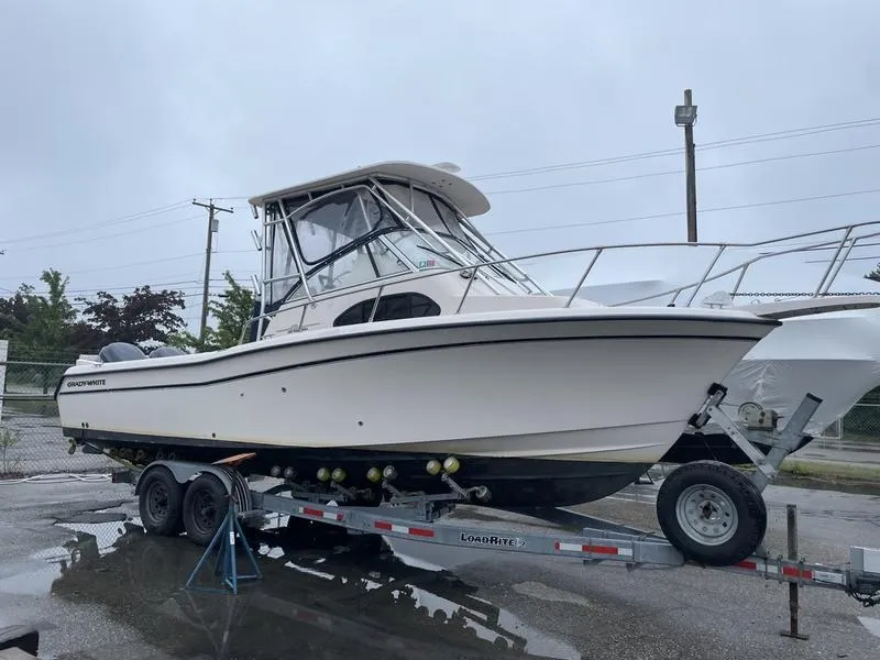 Slide: The Image of 2003 Grady-White Sailfish 282 boat on trailer, parked outdoors on a cloudy day. - 5