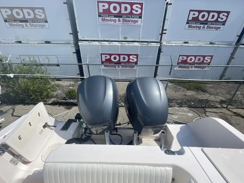Slide: The Image of 2003 Grady-White Sailfish 282 boat with dual outboard motors, near PODS storage units. - 7