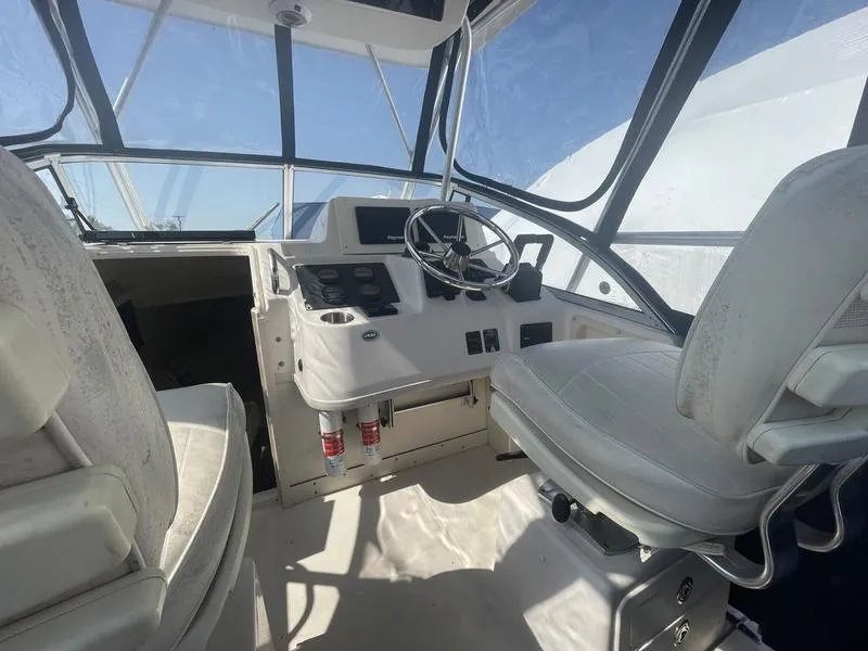 Slide: The Image of 2003 Grady-White Sailfish 282 boat interior with steering wheel and control panel. - 8