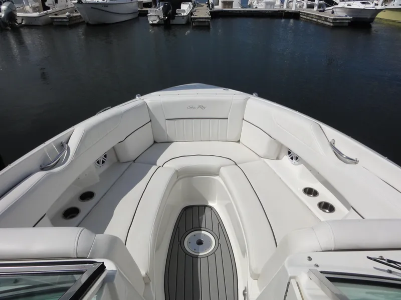 Slide: The Image of 2009 Sea Ray 250 SLX boat with white seating and cup holders, docked at marina. - 12