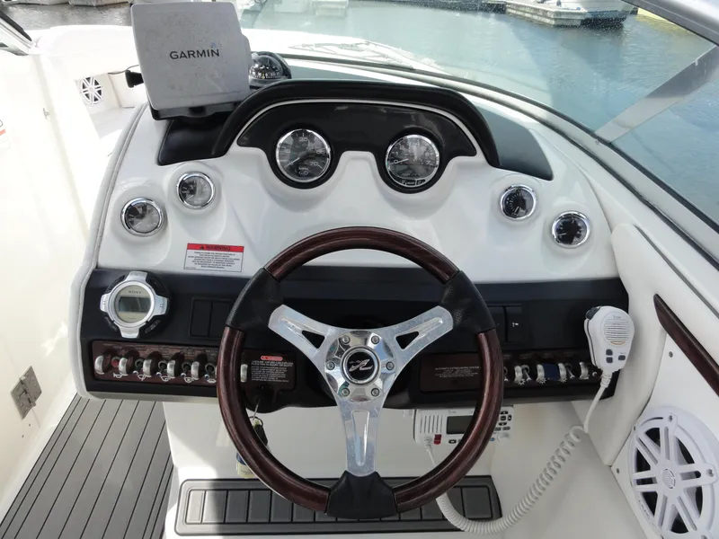 Slide: The Image of 2009 Sea Ray 250 SLX boat dashboard with Garmin GPS and steering wheel. - 15