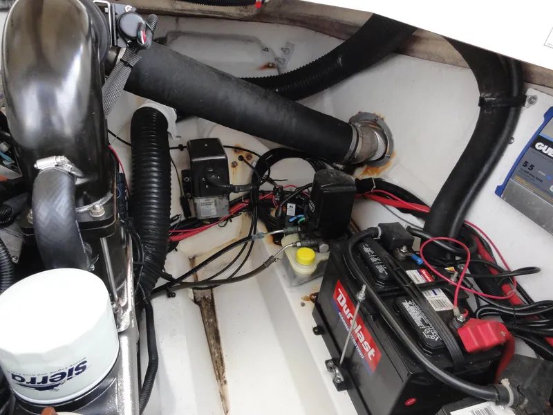 Slide: The Image of Engine compartment of a 2009 Sea Ray 250 SLX boat, featuring battery and wiring components. - 22