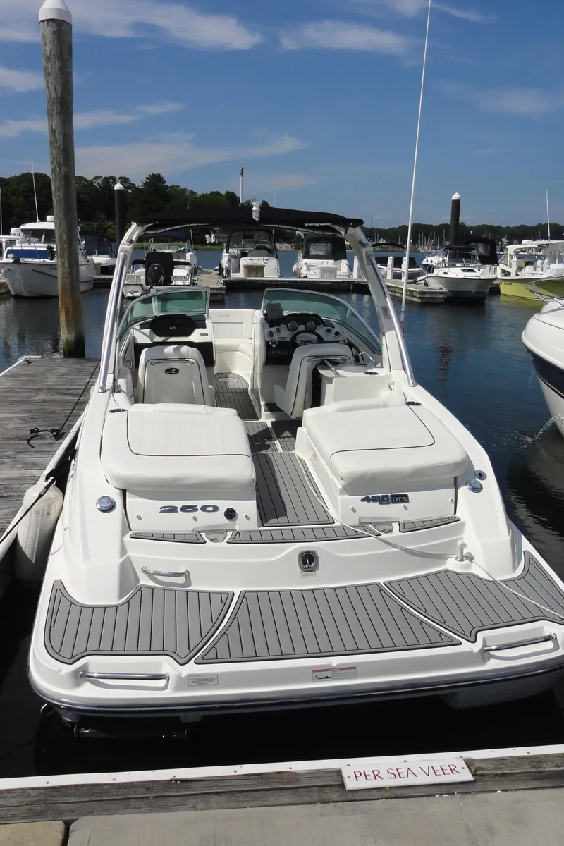 Slide: The Image of 2009 Sea Ray 250 SLX boat docked at marina, showcasing sleek design and spacious seating. - 3