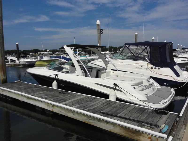 Slide: The Image of 2009 Sea Ray 250 SLX boat docked at a marina under a clear blue sky. - 4