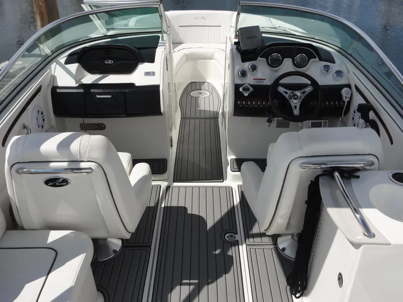Slide: The Image of 2009 Sea Ray 250 SLX boat interior with white seating and modern dashboard. - 8