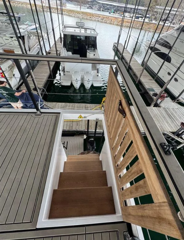 Slide: The Image of Staircase on Navisyo Homes NV.08 houseboat, docked with other boats, 2022 model. - 16