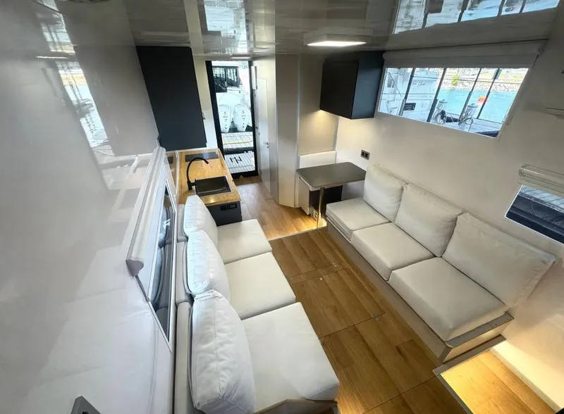 Slide: The Image of Modern Navisyo Homes NV.08 interior, 2022 model, featuring sleek design, white sofas, and wooden flooring. - 19