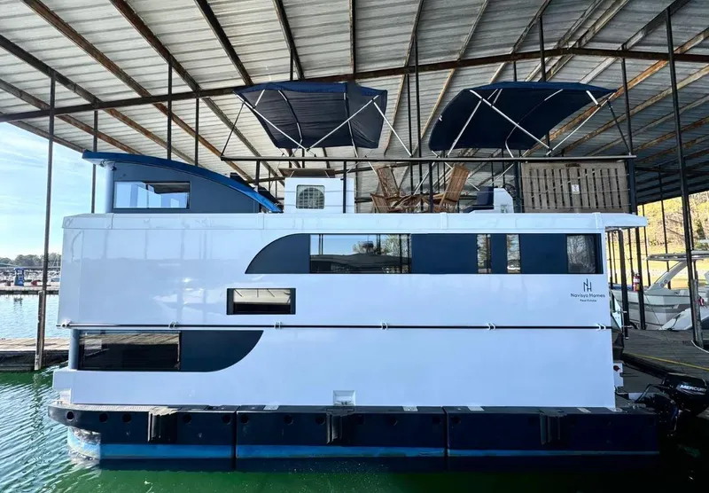 Slide: The Image of Modern 2022 Navisyo Homes NV.08 houseboat docked under a covered marina. - 20