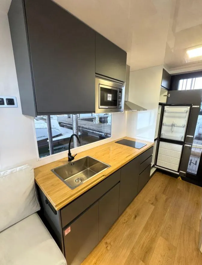 Slide: The Image of Modern kitchen in 2022 Navisyo Homes NV.08 with wood countertops and sleek appliances. - 21