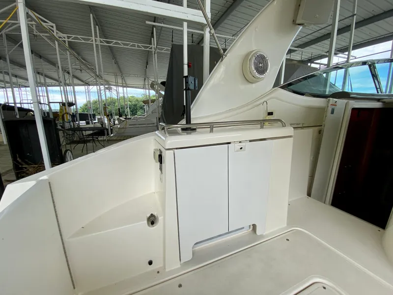 Slide: The Image of 2007 Cruisers Yachts 370 Express interior with white cabinetry and speaker in covered dock. - 10