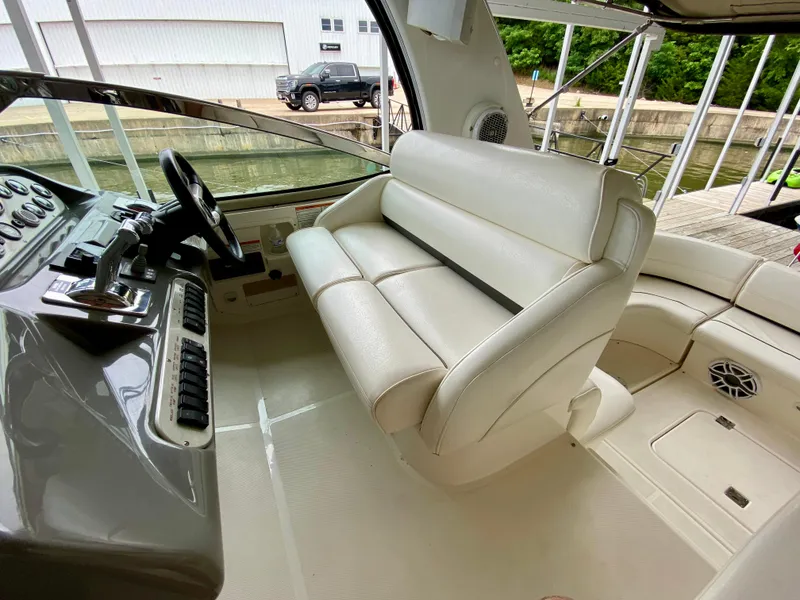 Slide: The Image of 2007 Cruisers Yachts 370 Express helm with white seating and control panel. - 15