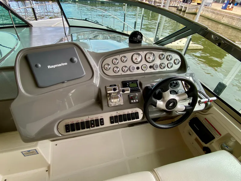 Slide: The Image of 2007 Cruisers Yachts 370 Express helm with Raymarine navigation system and steering wheel. - 19