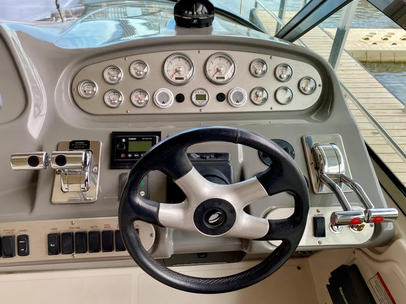 Slide: The Image of 2007 Cruisers Yachts 370 Express helm with steering wheel and control panel. - 20